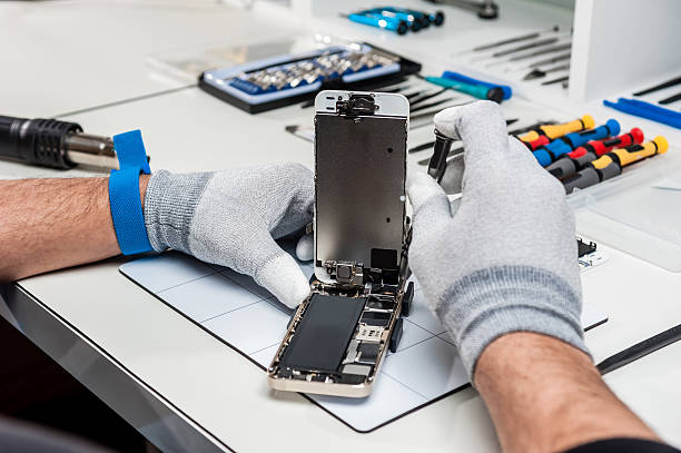 Technician replacing the screen of a used smartphone